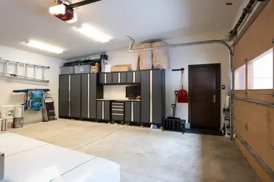 a garage with gray cabinets and a door in it at West Shore - West Shore Hideaway in Tahoma