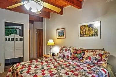 a bedroom with a bed and a ceiling fan at Hot Tub, Deck and Trail Access Shaver Lake Cabin in Shaver Lake