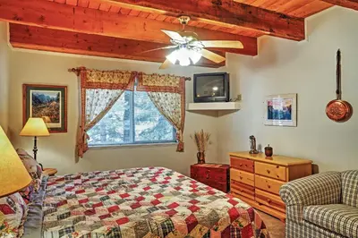 a bedroom with a bed and a ceiling fan at Hot Tub, Deck and Trail Access Shaver Lake Cabin in Shaver Lake