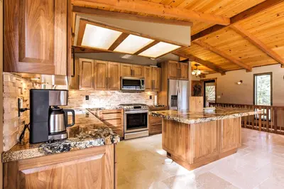 a large kitchen with wooden cabinets and granite counter tops at Cozy Lake-View Hideaway! Pet-Friendly Truckee Home in Truckee