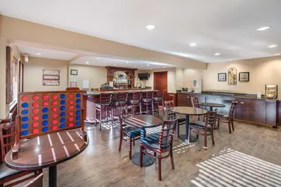 a restaurant with tables and chairs and a giant ball pit at Best Western Plus Orchid Hotel & Suites in Roseville