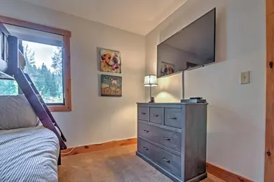 a bedroom with a bed and a dresser with a flat screen tv at Northstar Resort Shuttle Access Truckee Condo in Truckee