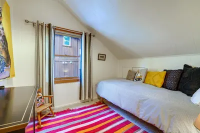 a bedroom with a bed and a window at Boutique and Artsy Log Cabin in North Lake Tahoe! in Kings Beach