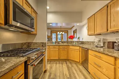 a large kitchen with wooden cabinets and stainless steel appliances at Forest-View Gem 2 Mi to Diamond Peak Ski Resort! in Incline Village
