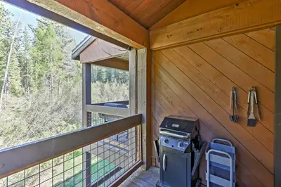 a screened in porch with a grill on a deck at Modern Condo with Balcony - Walk to Northstar Lifts! in Truckee