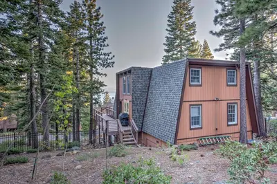 a tiny house with a staircase in the woods at 10 Mi to Skiing Tahoe City A-Frame Home in Tahoe City