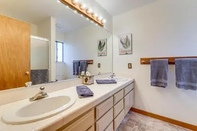 a bathroom with two sinks and a large mirror at Family-Friendly Truckee Cabin Near Ski Shuttle! in Truckee