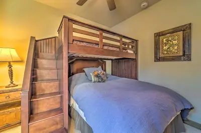 a bedroom with a bunk bed with a ladder at Central Mammoth Lakes Townhome about 1 Mi to Slopes in Mammoth Lakes