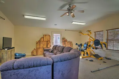 a living room with a large couch and a gym at Casa dAmore Extravagant Lakefront Villa! in Granite Bay