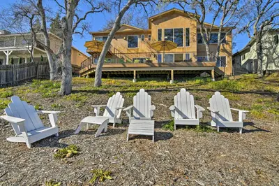 a group of chairs sitting in front of a house at Casa dAmore Extravagant Lakefront Villa! in Granite Bay