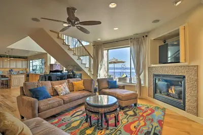 a living room with a couch and a fireplace at Casa dAmore Extravagant Lakefront Villa! in Granite Bay