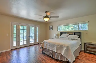 a bedroom with a bed and a ceiling fan at 7 Mi to Dtwn Gilroy Spacious Home on 20 Acres! in Gilroy