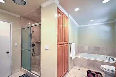 a bathroom with a tub and a shower and a toilet at 7 Mi to Dtwn Gilroy Spacious Home on 20 Acres! in Gilroy