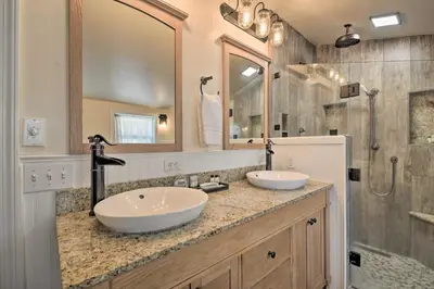 a bathroom with two sinks and a shower at Historic Mariposa Stagecoach Stop with Gas Fire Pit! in Mariposa