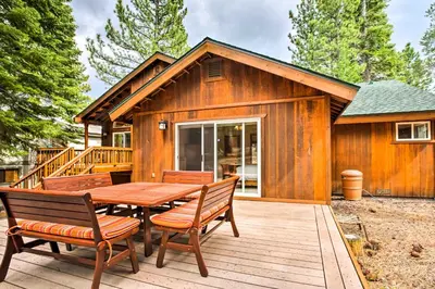 a cabin with a wooden table and chairs on a deck at Hot Tub Access, Near Skiing Tahoe Donner Cabin in Truckee