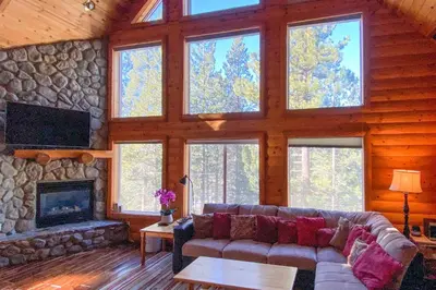 a living room with a couch and a stone fireplace at Hot Tub, Indoor Pool! Home 8 Mi to Heavenly Skiing in South Lake Tahoe