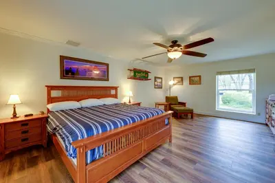 a bedroom with a bed and a ceiling fan at 7 Mi to Bass Lake! Spacious Mudge Ranch Retreat in Coarsegold