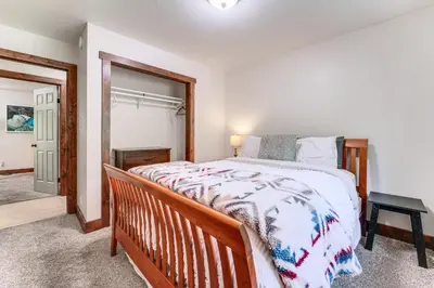 a bedroom with a large bed and a mirror at Less Than 15 Mi to 6 Ski Resorts Tahoe Donner Escape! in Truckee