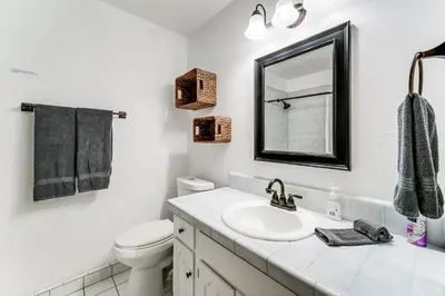 a white bathroom with a sink and a mirror at Less Than 15 Mi to 6 Ski Resorts Tahoe Donner Escape! in Truckee