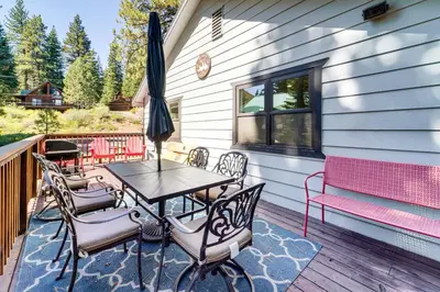 a patio with a table and chairs and an umbrella at Less Than 15 Mi to 6 Ski Resorts Tahoe Donner Escape! in Truckee