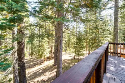 a wooden deck with a view of a forest at Less Than 15 Mi to 6 Ski Resorts Tahoe Donner Escape! in Truckee