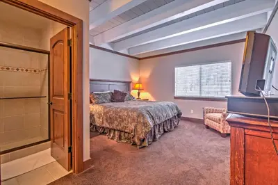 a bedroom with a bed and a tv and a tub at Private Deck and Community Pool Incline Village Gem in Incline Village