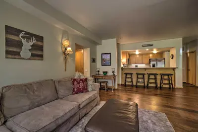 a living room with a couch and a kitchen at Mammoth Lakes Vacation Rental with Community Hot Tub in Mammoth Lakes