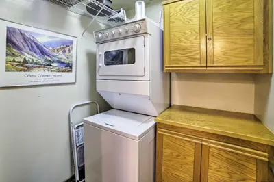a small kitchen with a refrigerator and a microwave at Mammoth Lakes Vacation Rental with Community Hot Tub in Mammoth Lakes