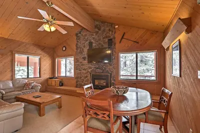 a living room with a table and a couch at Rustic Truckee Lodge with Rec Room - Near Northstar! in Truckee
