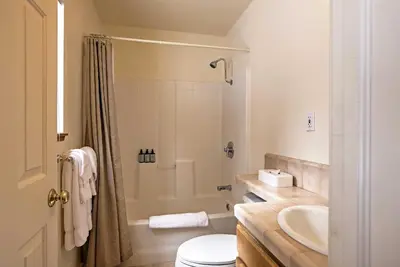a bathroom with a shower and a toilet and a sink at Rustic Truckee Lodge with Rec Room - Near Northstar! in Truckee