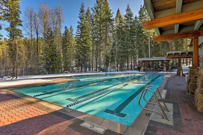 a swimming pool in the middle of a forest at Rustic Truckee Lodge with Rec Room - Near Northstar! in Truckee