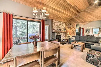 a living room with a table and a couch at Renovated Mammoth Lakes Retreat with Private Balcony in Mammoth Lakes