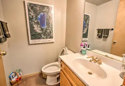 a bathroom with a sink and a toilet and a mirror at Cabin Less Than 2 Mi to Tahoe Donner Downhill Ski Resort in Truckee