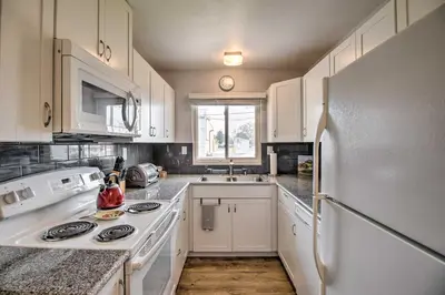 a kitchen with white cabinets and a white refrigerator at Ski, Hike and Unwind Cozy Carson City Duplex! in Carson City