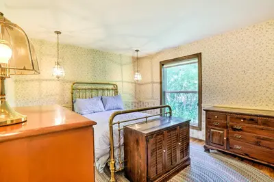 a bedroom with a bed and a dresser and a desk at Rustic Riverfront Truckee Cabin with Deck and BBQ in Truckee