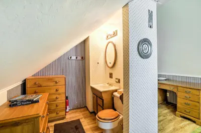 a bathroom with a toilet and a sink and a drawer at Rustic Riverfront Truckee Cabin with Deck and BBQ in Truckee