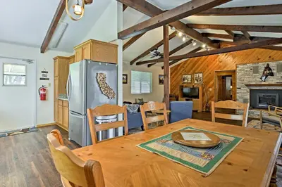 a kitchen and dining room with a table and a fireplace at Cozy Home with Patio Near Yosemite National Park! in Mariposa