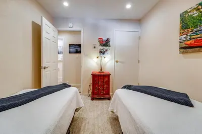 a bedroom with two beds and a lamp on a table at 1 Mi to Diamond Peak Ski Resort Condo with Pool in Incline Village