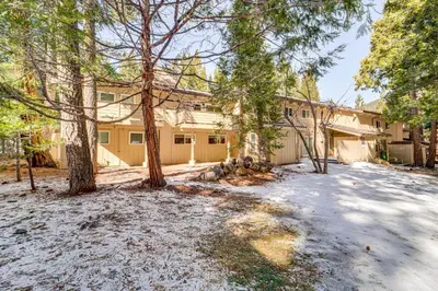 a house with trees in front of it at 1 Mi to Diamond Peak Ski Resort Condo with Pool in Incline Village
