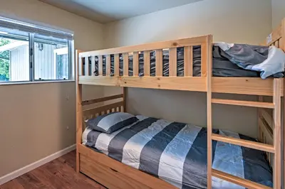 a bedroom with two bunk beds and a window at Remodeled and Cozy Gilroy Guest House Near Downtown! in Gilroy