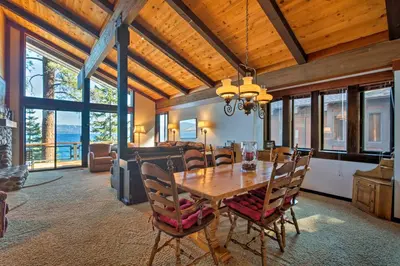a dining room with a wooden table and chairs at 11 Mi to Palisades Tahoe Lakefront Home with View! in Tahoe City
