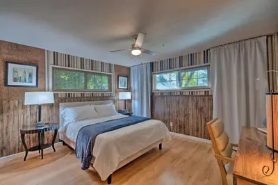 a bedroom with a bed and two windows and a desk at Spacious Wine Country Home 1 Mi to Downtown Lodi! in Lodi