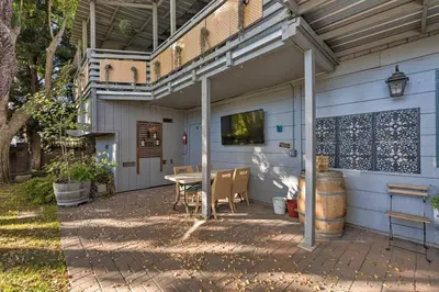 a patio with a table and a tv on a wall at Spacious Wine Country Home 1 Mi to Downtown Lodi! in Lodi