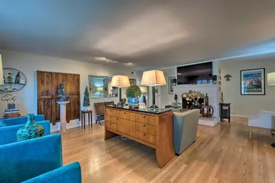 a living room with a blue couch and a table at Spacious Wine Country Home 1 Mi to Downtown Lodi! in Lodi