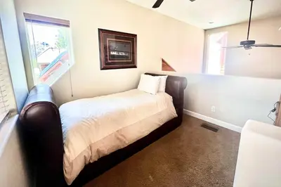 a bedroom with a bed in a room with a window at Mammoth Lakes Townhome - 10-Min Walk to Village! in Mammoth Lakes