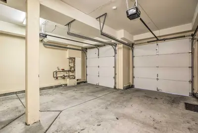 an empty garage with two garage doors in it at Mammoth Lakes Townhome - 10-Min Walk to Village! in Mammoth Lakes