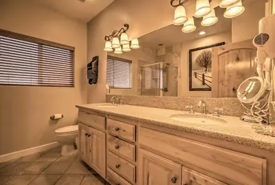a bathroom with a sink and a toilet and a mirror at Mammoth Lakes Townhome - 10-Min Walk to Village! in Mammoth Lakes