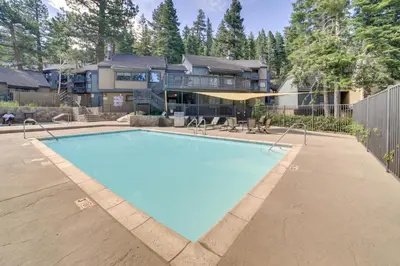 a large swimming pool in front of a house at Quiet Condo with Great Views, half Mi to Eagle Lodge! in Mammoth Lakes
