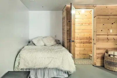 a bedroom with a bed with a white blanket at Strawberry Hill Cabin 5 Mi to Skiing and Lake in Strawberry