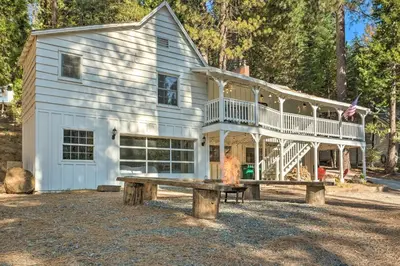a large white house with a bench in front of it at Strawberry Hill Cabin 5 Mi to Skiing and Lake in Strawberry